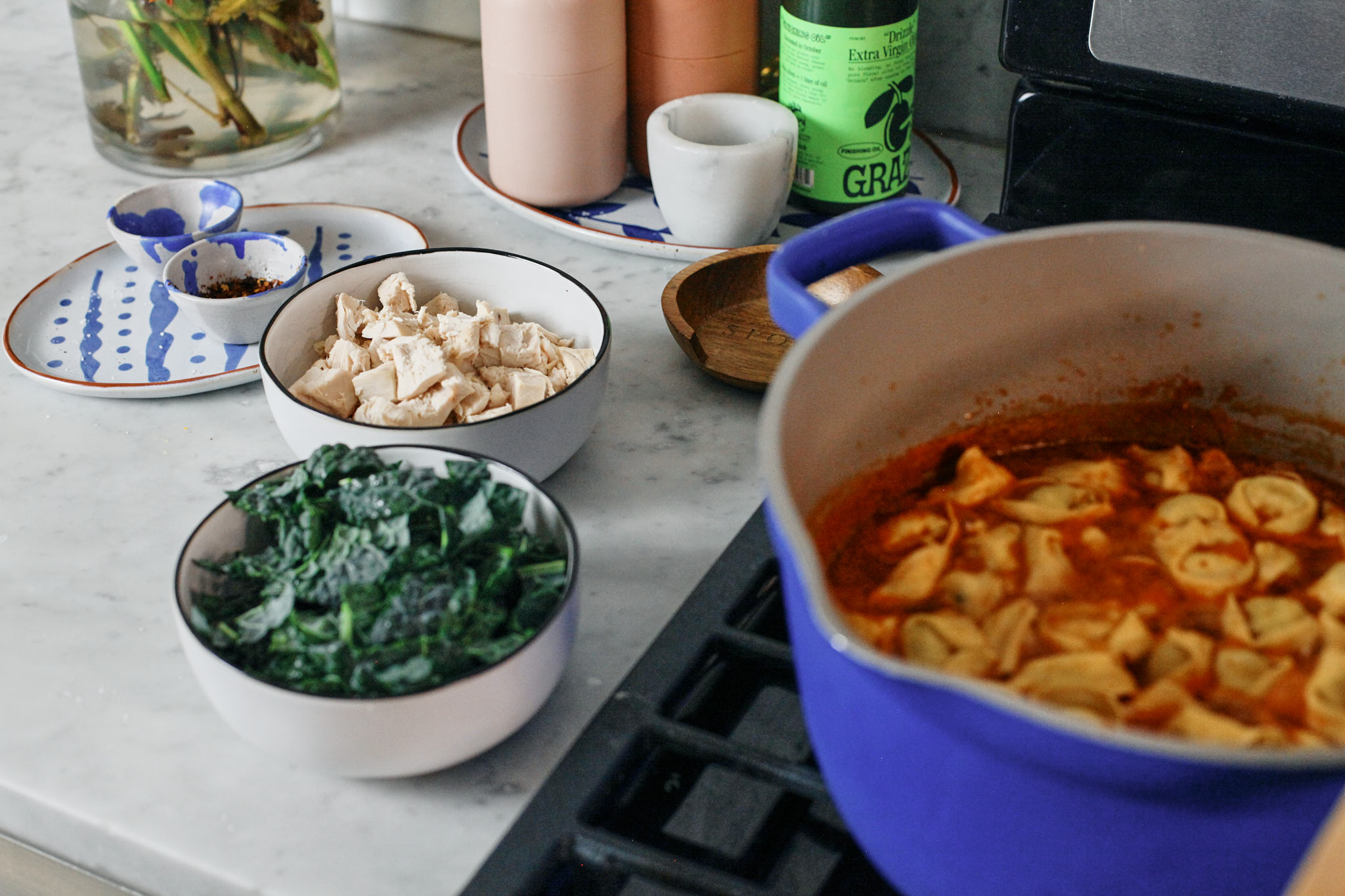 Tuscan Tortelini Soup 5 about to add chopped kale and chicken to tuscan tortellini soup