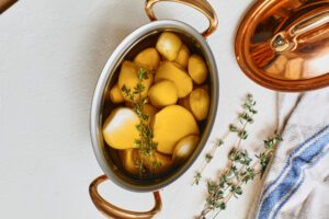 Garlic Confit Pasta garlic cloves submerged in olive oil with fresh thyme
