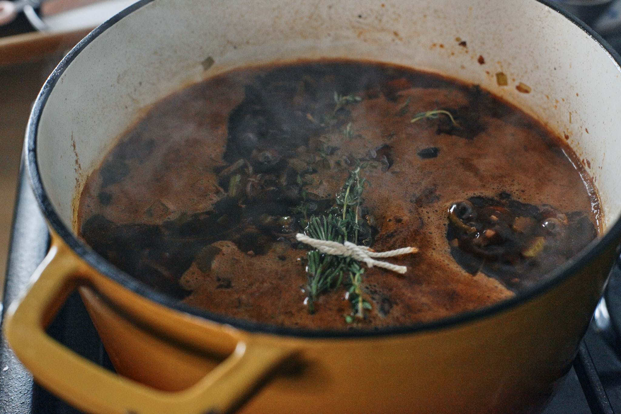 Ox Tail 8 oxtail ready to braise with the wine and stock up to a simmer, finished with a bouquet of herbs
