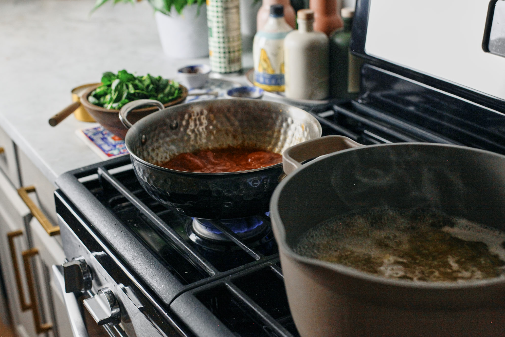 pasta cooking and tomato sauce simmering