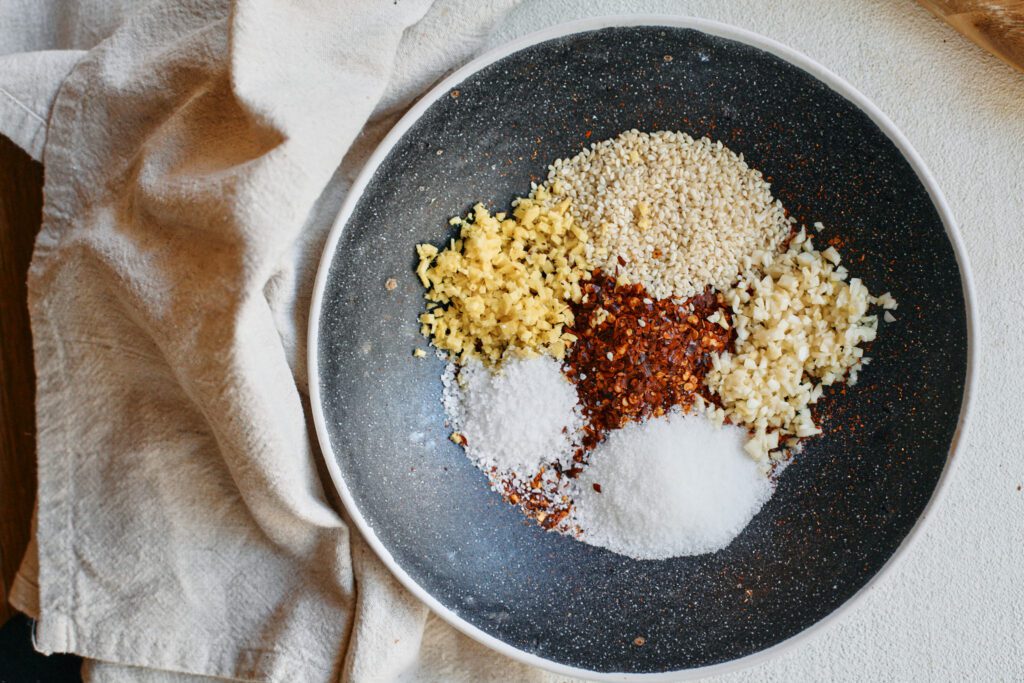 red chili flakes, sesame seeds and minced garlic, ginger, sugar and salt