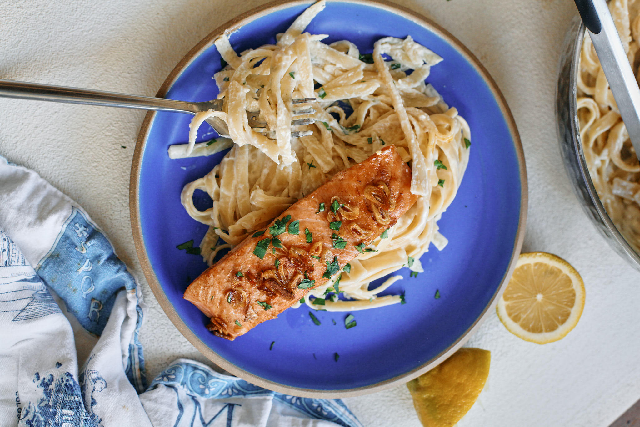 garlic butter salmon over creamy lemon pasta
