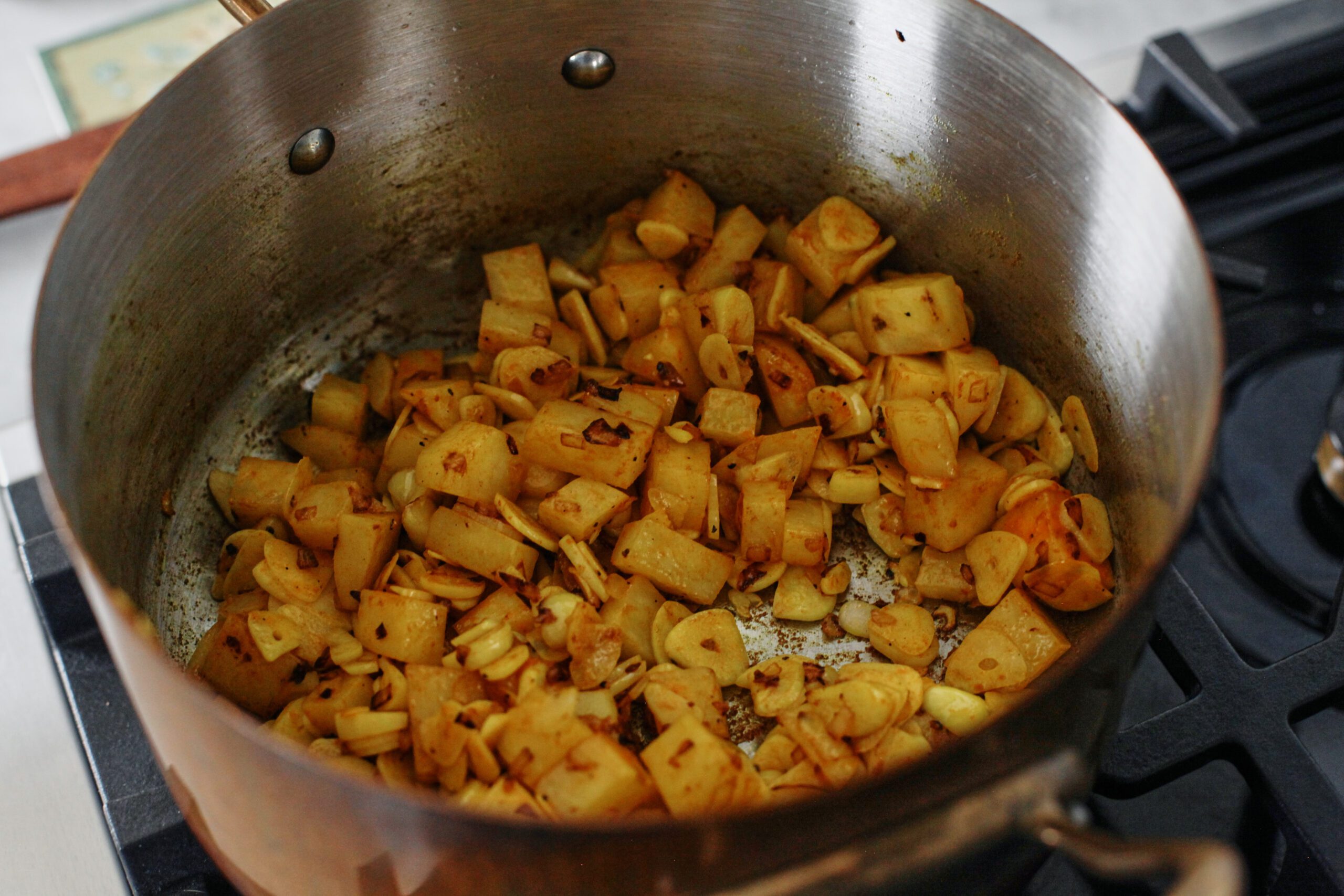 chopped potato and sliced garlic sauteeing with the onions, with turmeric added