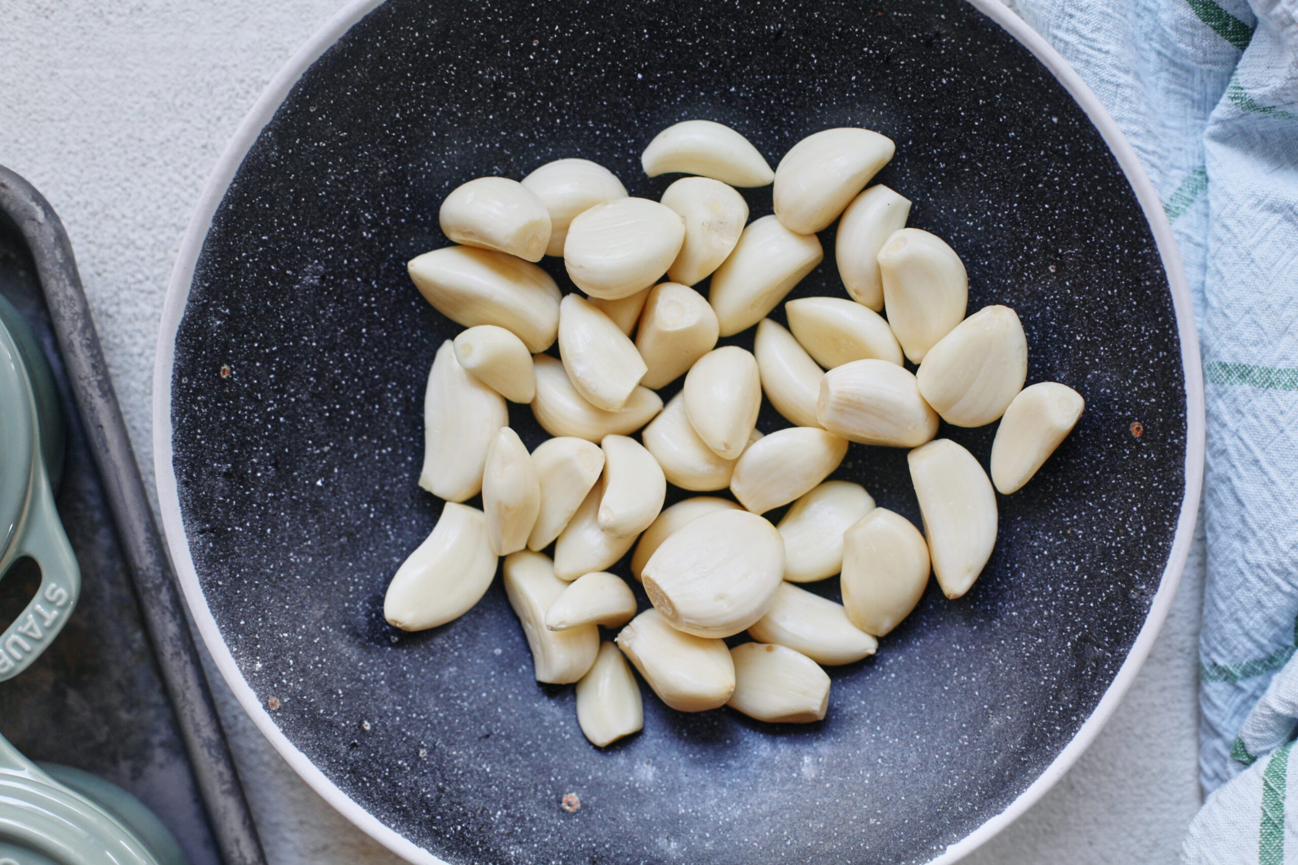 about 40 cloves of garlic in a large bowl