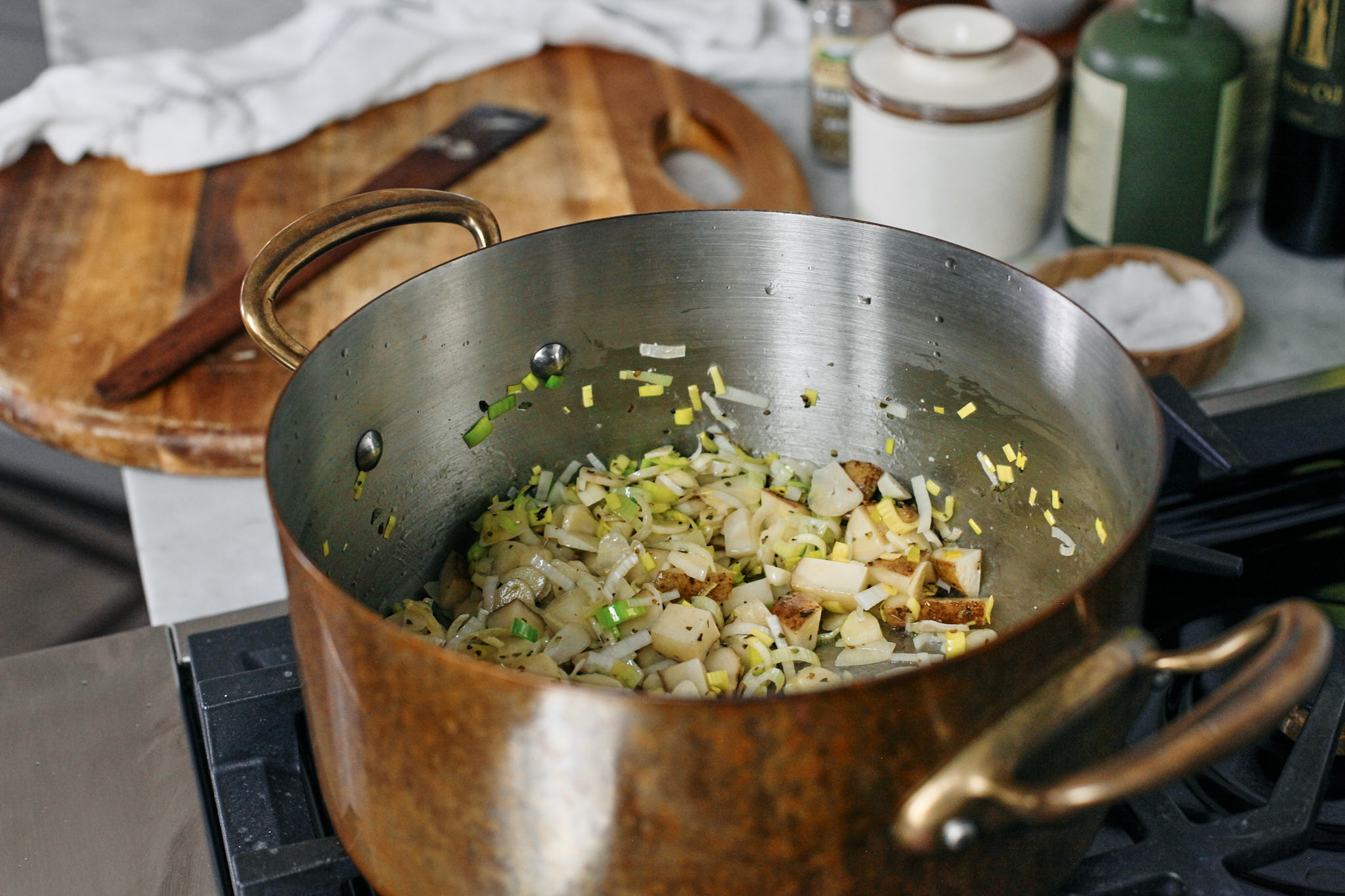 potato, leek and garlic sautéeing in butter and olive oil with some salt, pepper and marjoram seasoning.