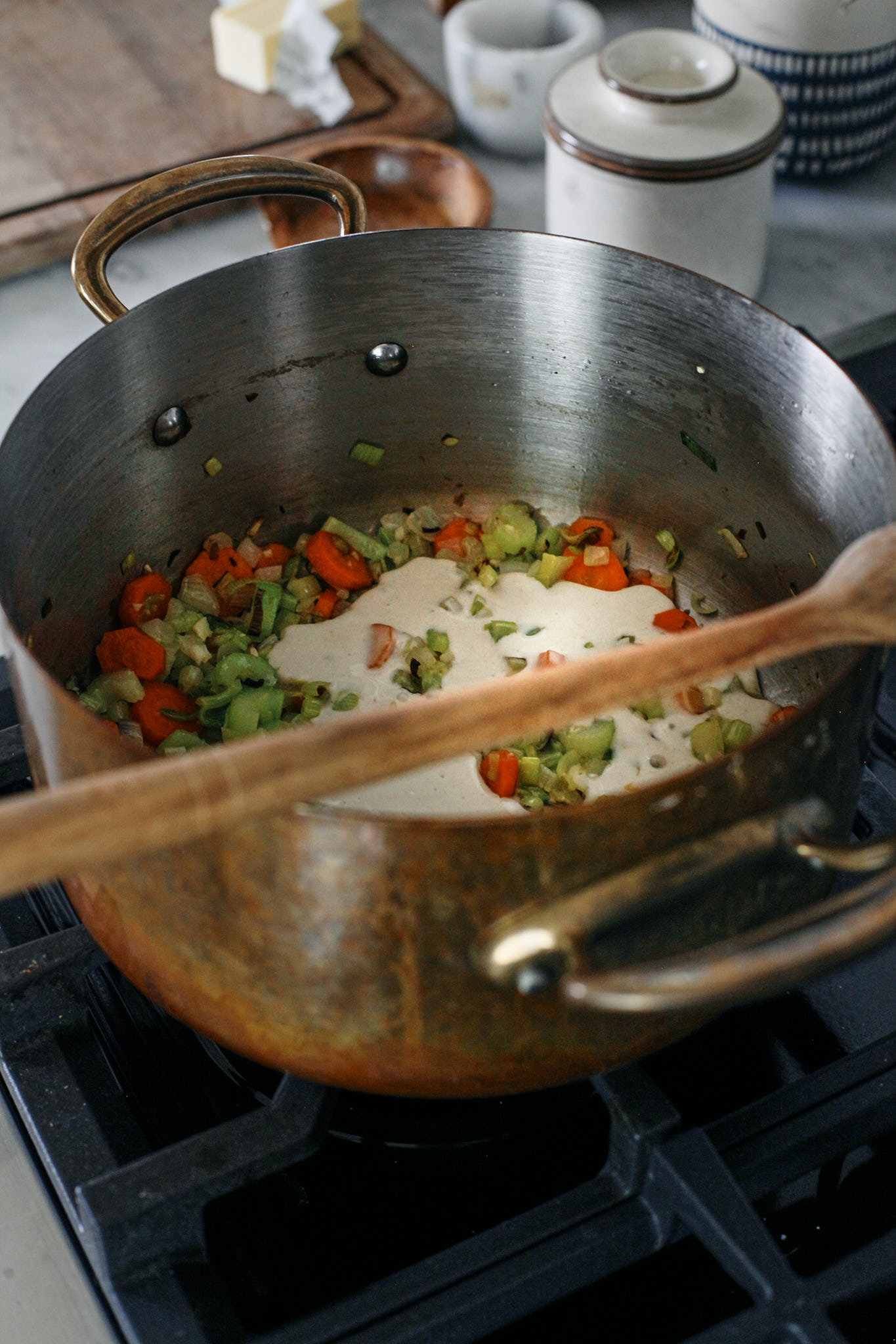 chopped celery, carrots, onion, leek and garlic in a large pot sautéeing in olive oil and butter. the sourdough discard is added as a roux to help thicken it up and provide more depth of flavour.