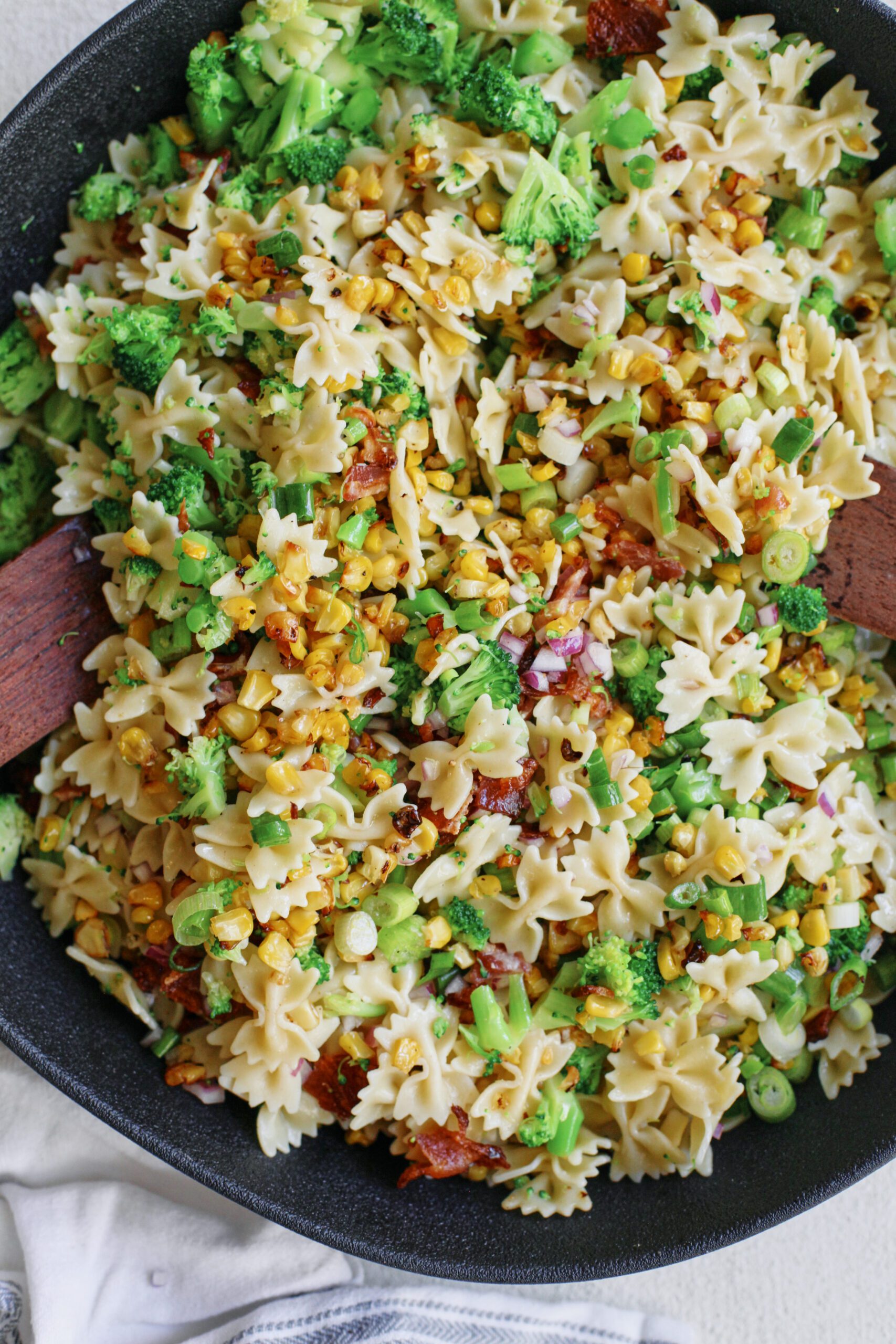 roasted corn, bacon, and broccoli salad roasted corn bacon and broccoli pasta salad with green onions, red onion and farfalle