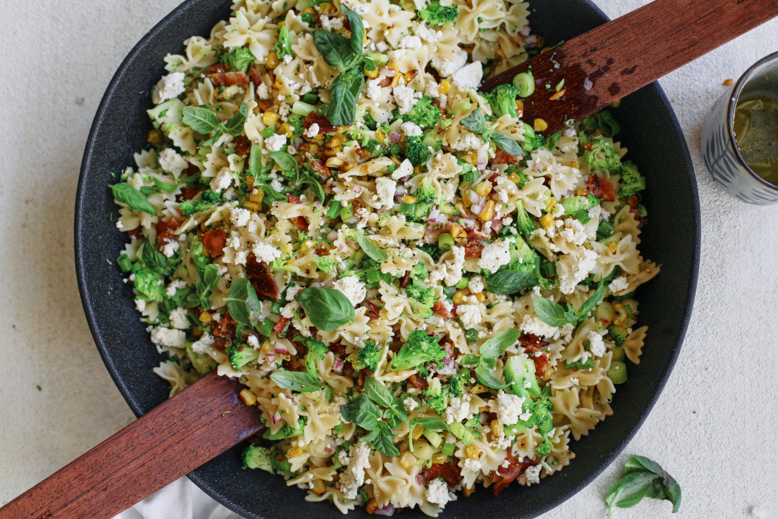 roasted corn, bacon, and broccoli salad roasted corn bacon and broccoli pasta salad with green onions, red onion and farfalle