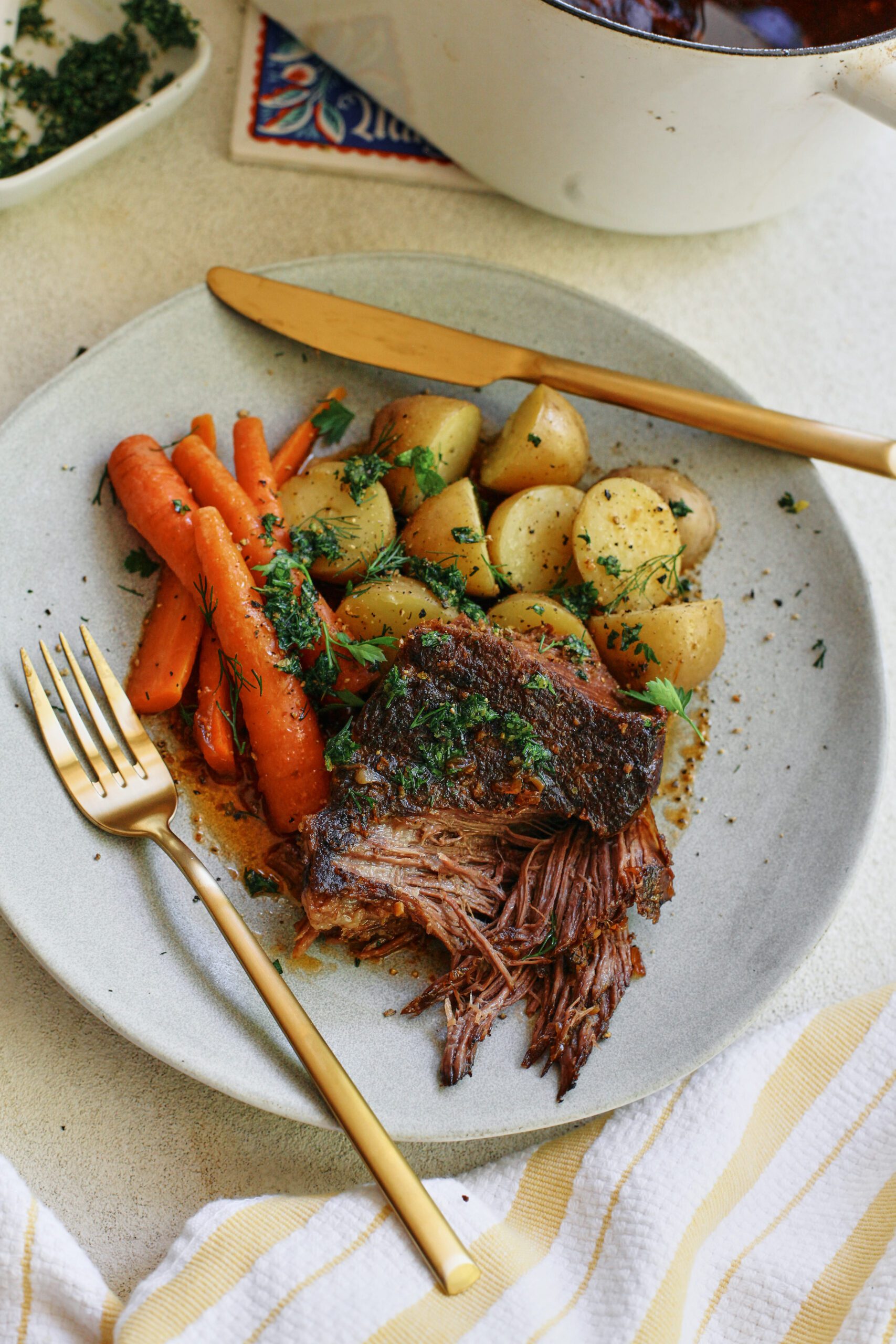 ale braised pot roast plated with baby potatoes and carrots