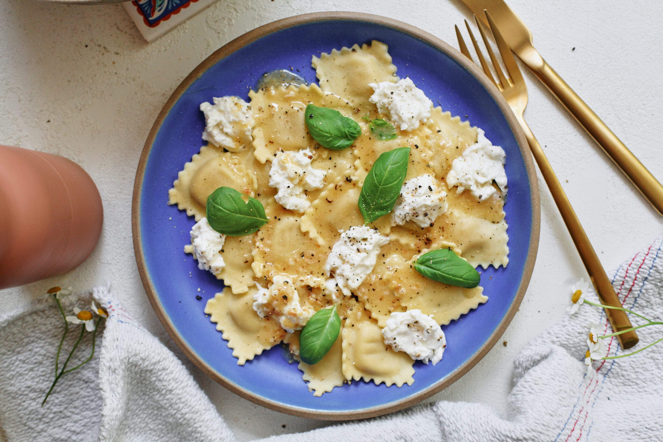 burrata & lemon ravioli, plated with basil and lemon zest