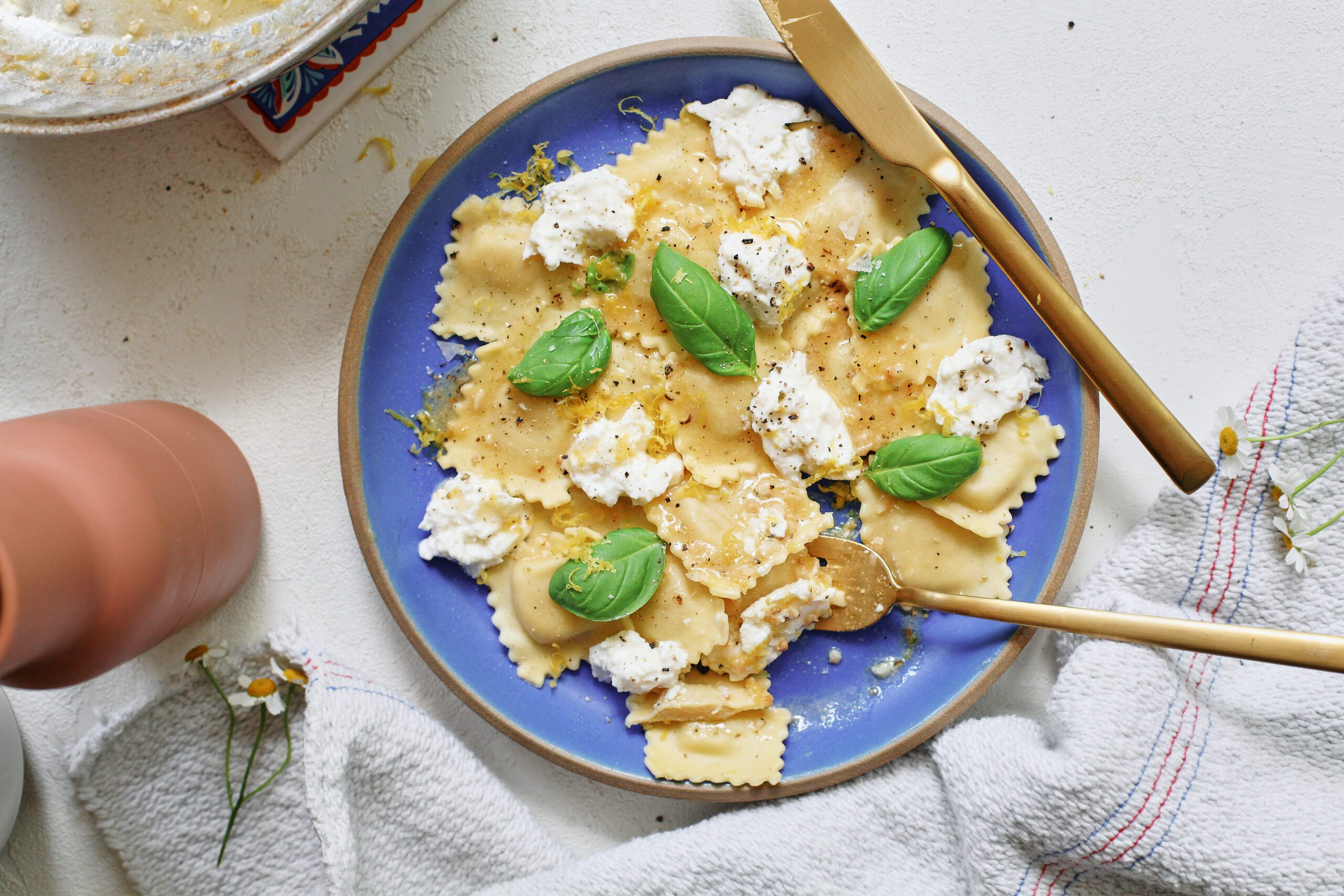 burrata & lemon ravioli, plated with basil and lemon zest