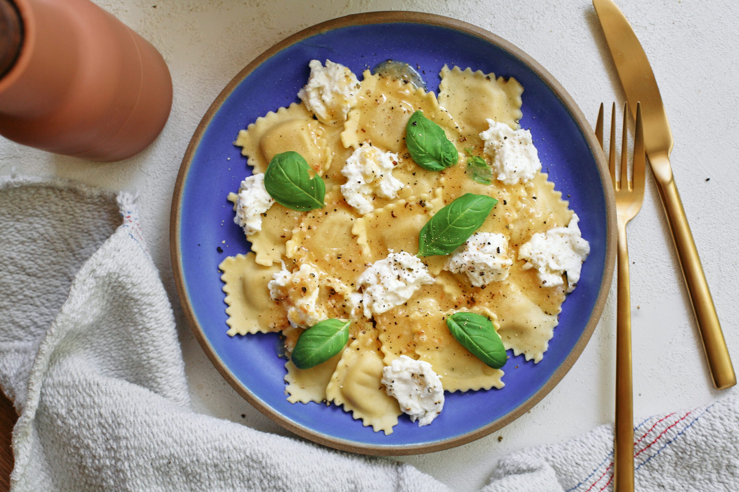 burrata & lemon ravioli, plated with basil and lemon zest