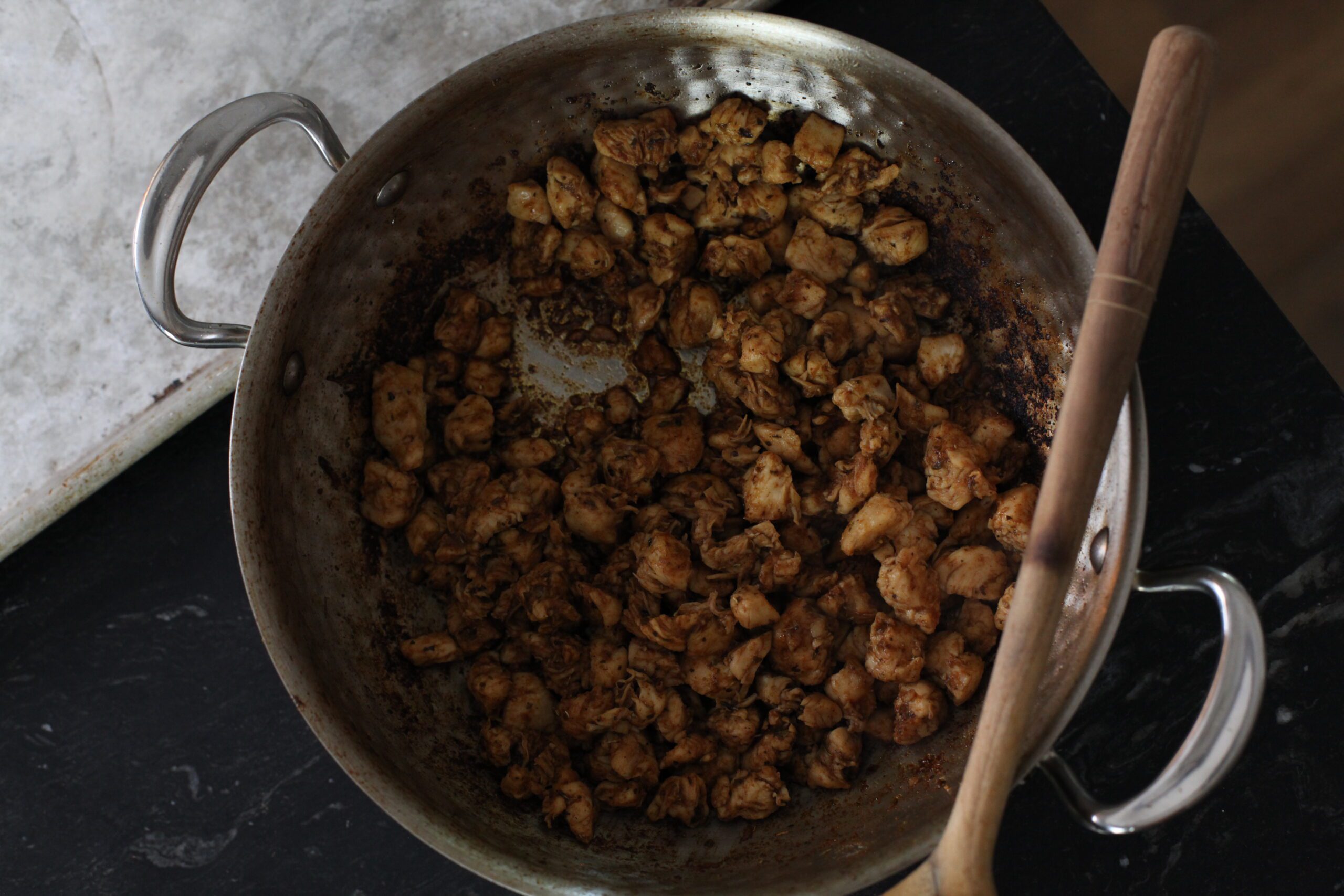 chicken in a pan after being cooked with spices