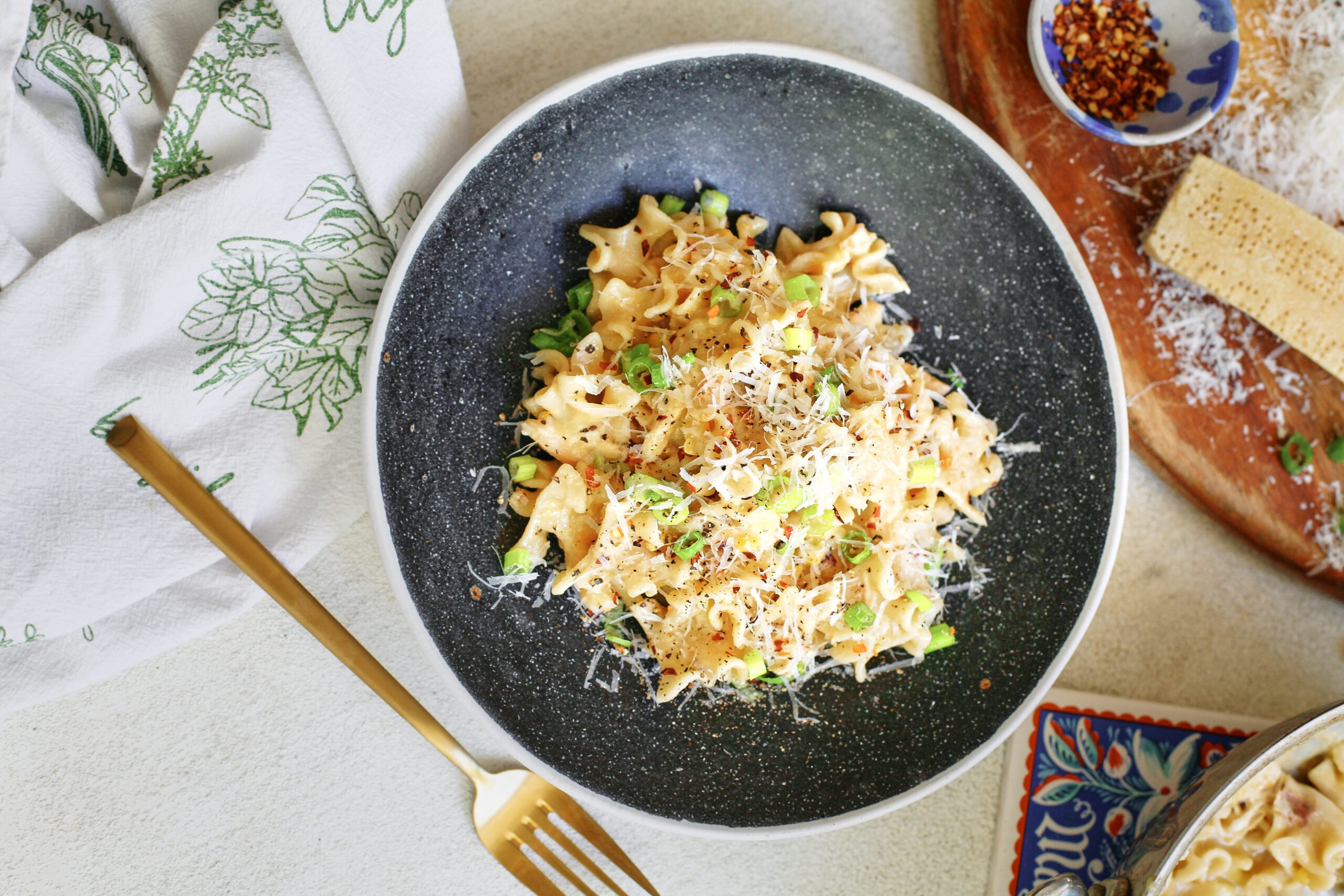 Creamy Corn and Chicken Pasta 11 creamy corn and chicken pasta in a charcoal-coloured bowl with a gold fork