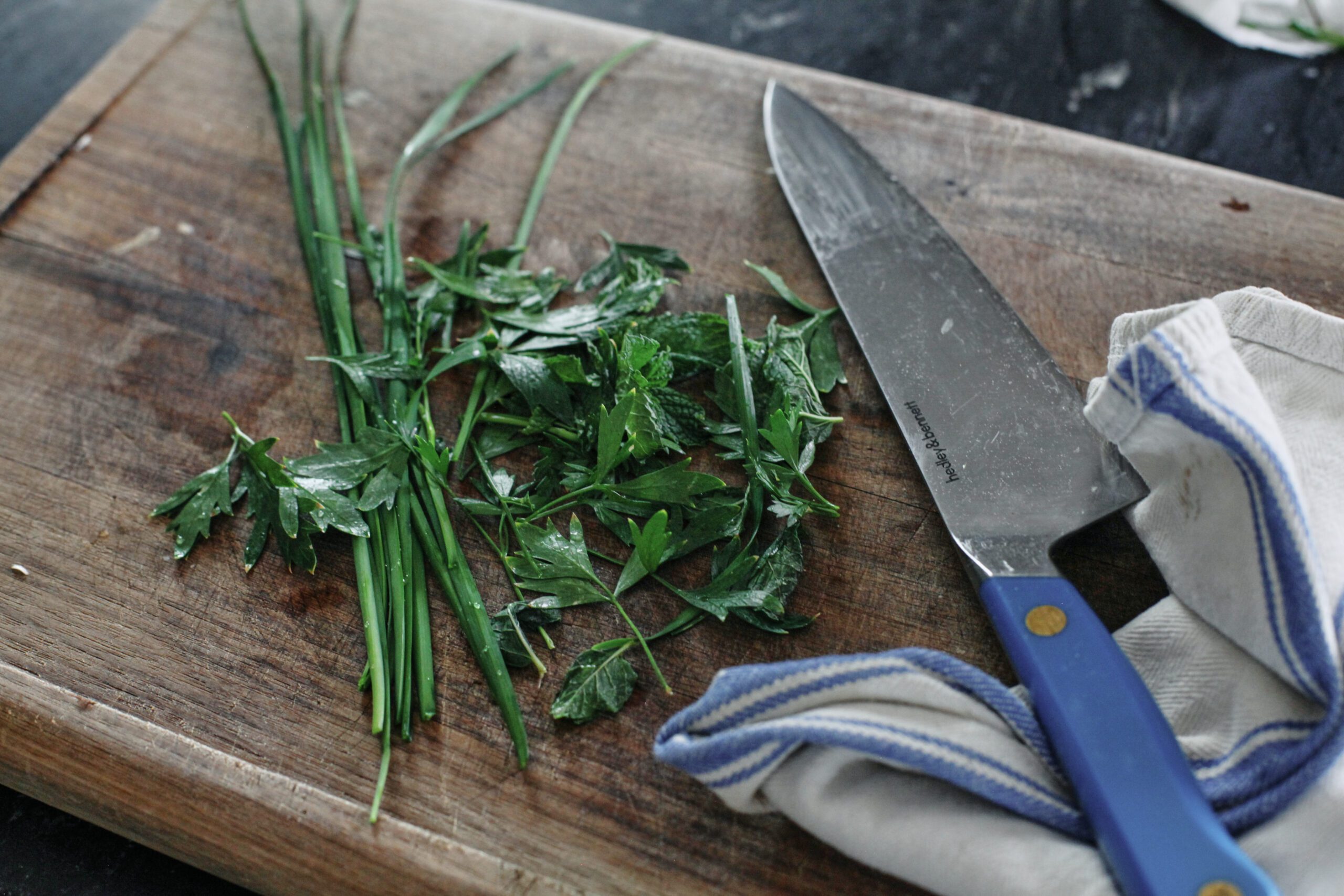 Salt and Vinegar Cauliflower 3 fresh herbs on a wooden cutting board with a knife
