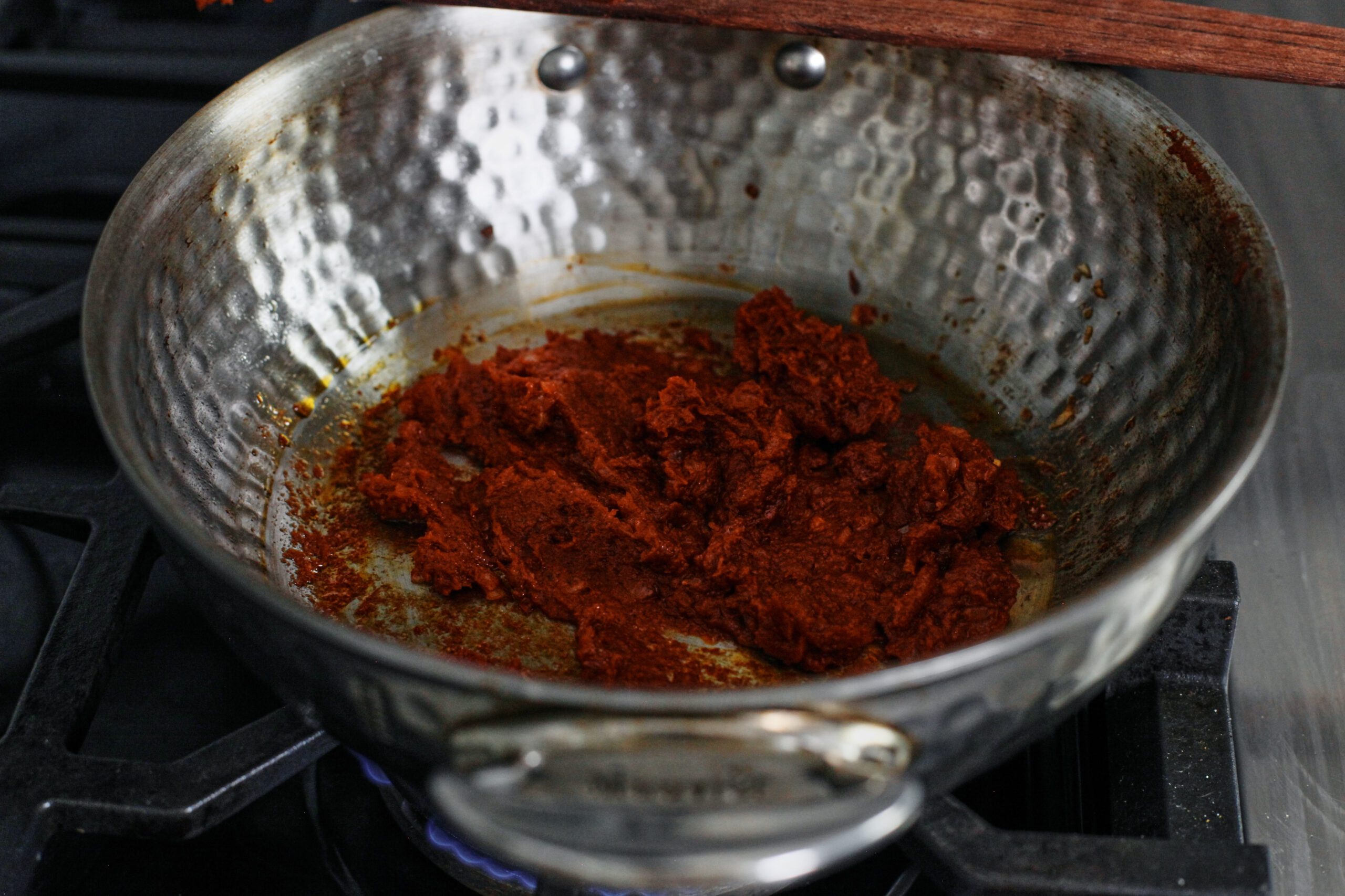 tomato paste being cooked in a pan