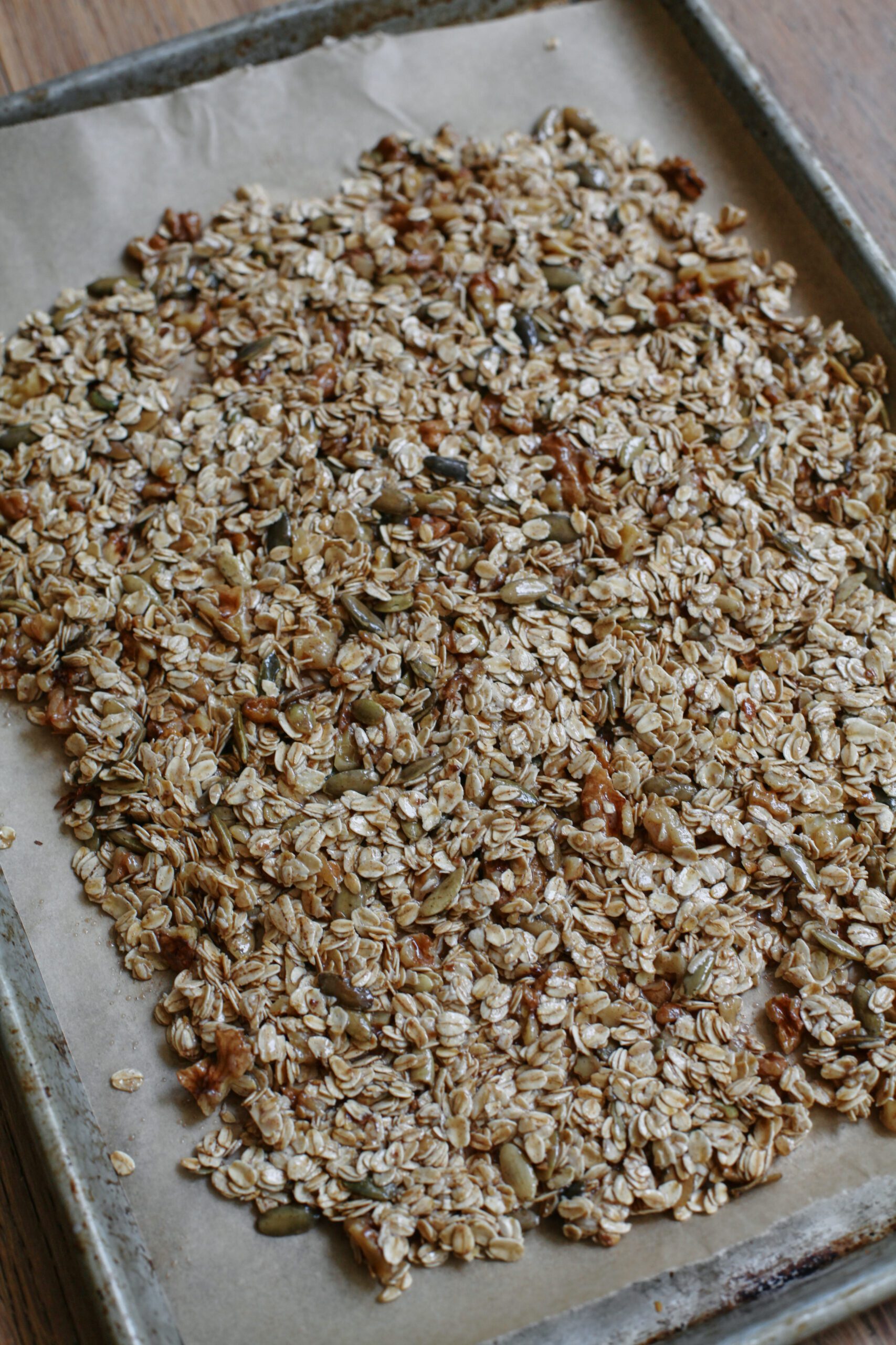 sourdough discard granola on a baking sheet before cooking