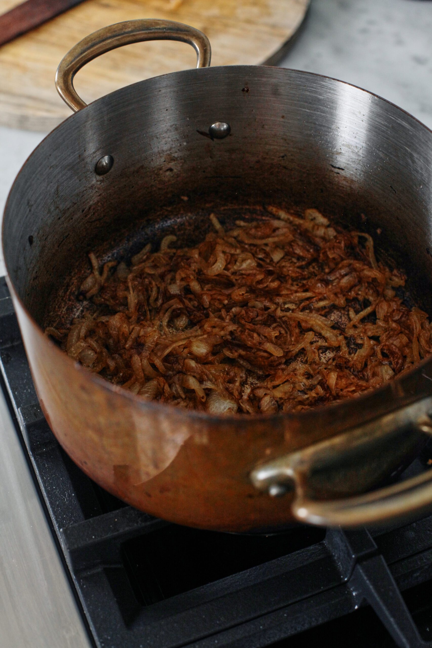 sliced onions caramelizing in a large pot