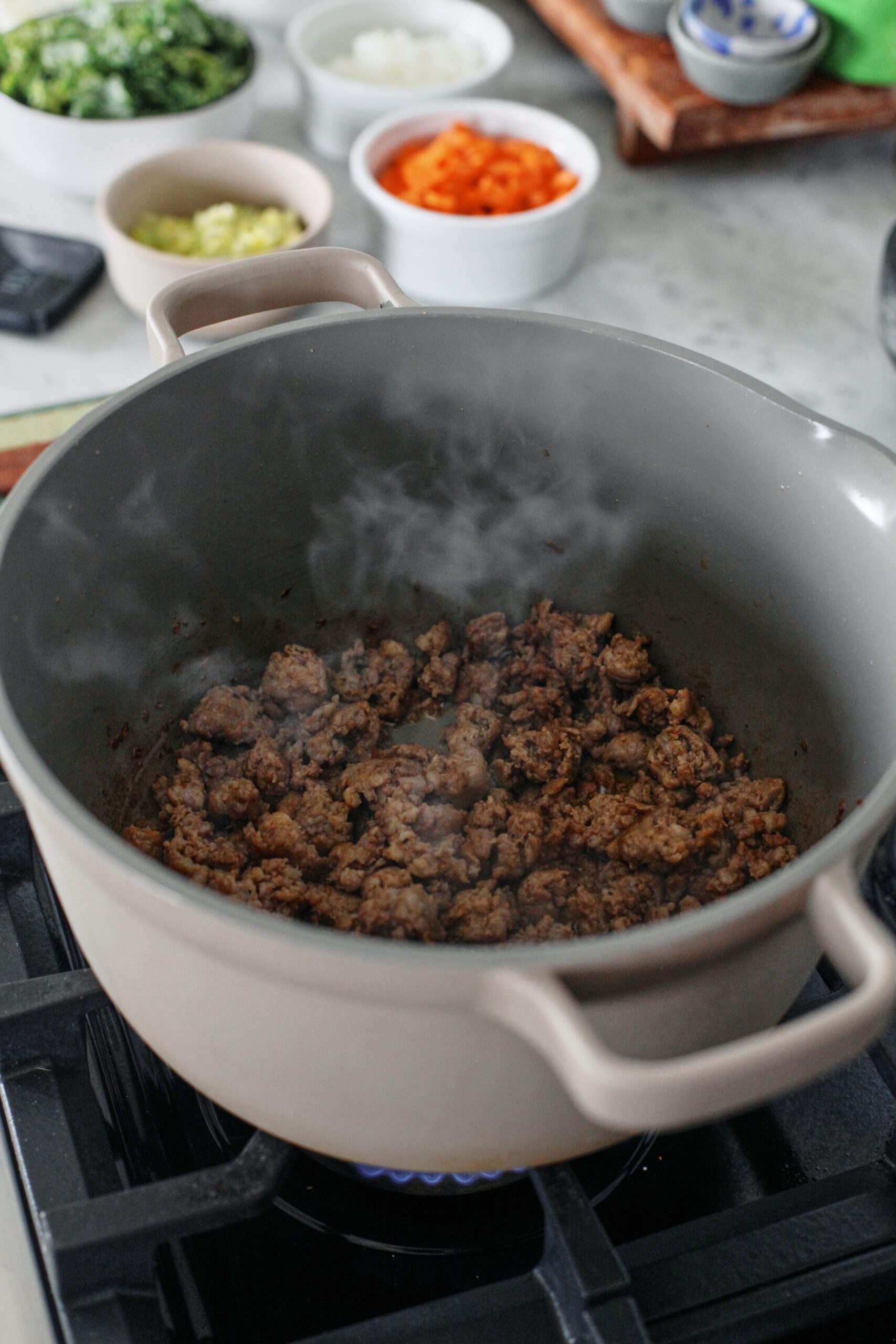 sausage browning in a large pot