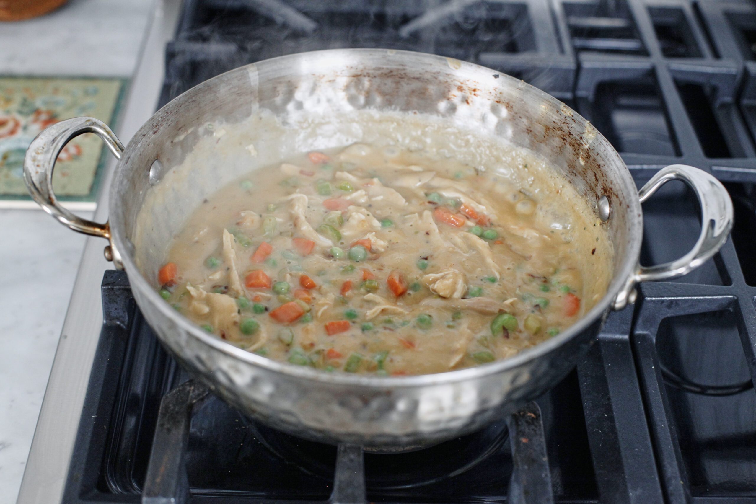 chicken pot pie filling in a stainless steel pan
