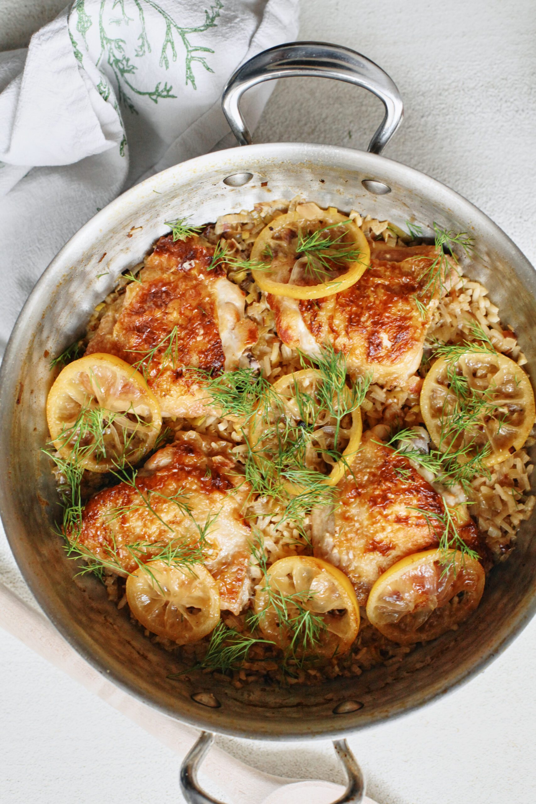 overhead photo of One Pot Lemony Dill Chicken and Rice in a deep hammered steel pan